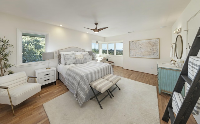 bedroom with light hardwood / wood-style floors and ceiling fan