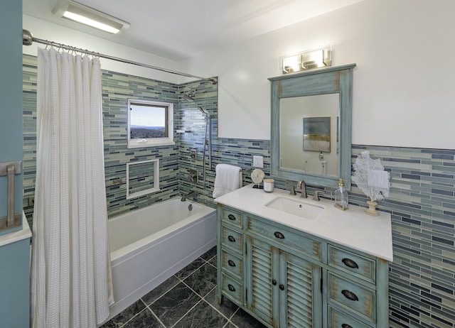 bathroom with shower / tub combo, vanity, and tile walls