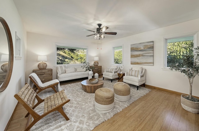 living room featuring hardwood / wood-style floors and ceiling fan