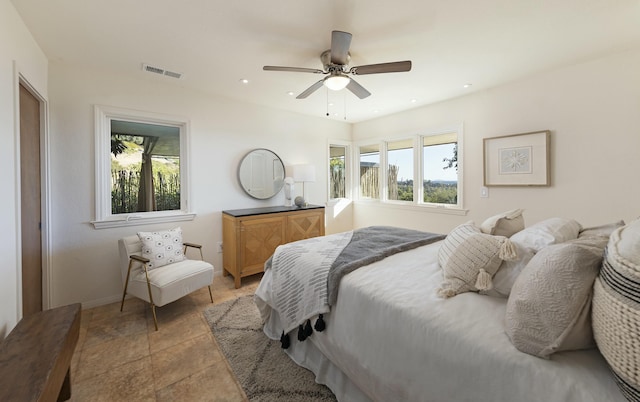 bedroom with ceiling fan and multiple windows