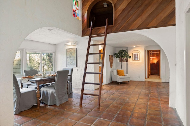 dining room with a textured ceiling and dark tile patterned floors