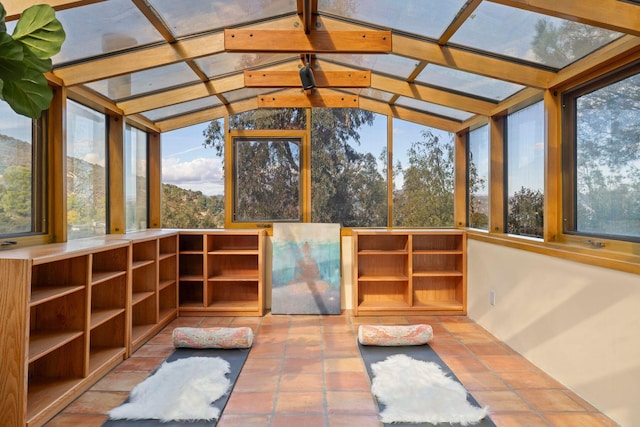 unfurnished sunroom featuring a healthy amount of sunlight and vaulted ceiling