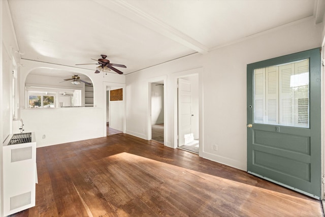 interior space with beam ceiling, ceiling fan, radiator heating unit, and dark hardwood / wood-style floors