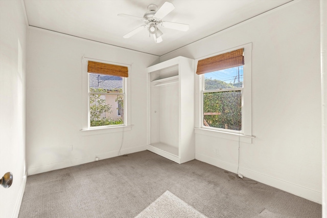 carpeted empty room featuring ceiling fan