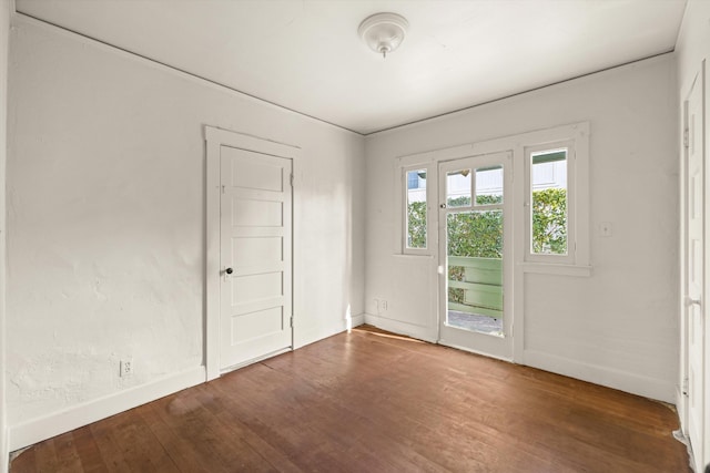 spare room with dark hardwood / wood-style flooring