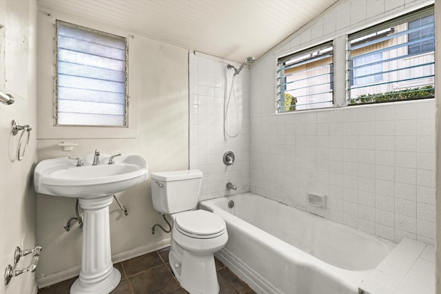 bathroom with vaulted ceiling, wooden ceiling, tile patterned flooring, toilet, and tiled shower / bath