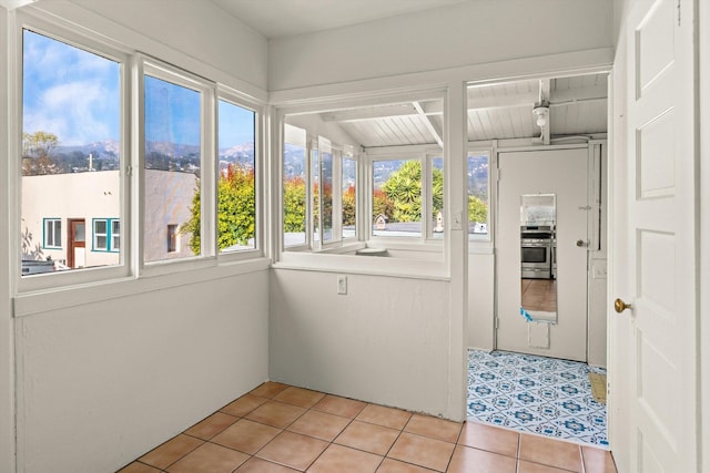 unfurnished sunroom with wood ceiling