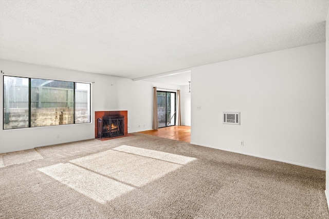 unfurnished living room with carpet floors and a textured ceiling