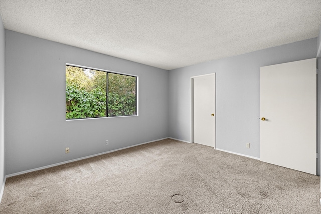 carpeted spare room featuring a textured ceiling