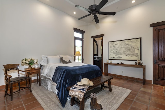 tiled bedroom featuring ceiling fan and a towering ceiling