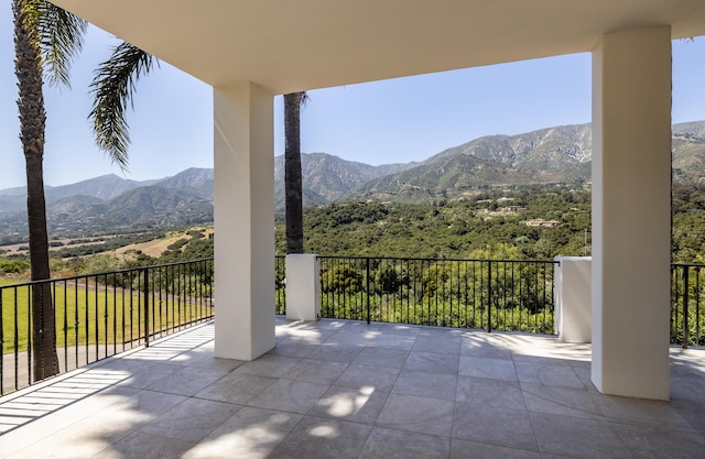 view of patio / terrace with a mountain view and a balcony