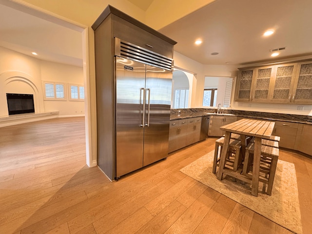 kitchen with light wood-type flooring, sink, and appliances with stainless steel finishes