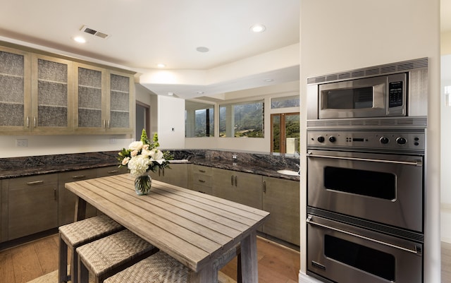 kitchen featuring kitchen peninsula, light hardwood / wood-style flooring, and appliances with stainless steel finishes