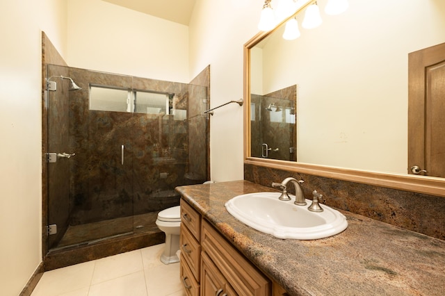 bathroom with toilet, vanity, tile patterned floors, and a shower with shower door