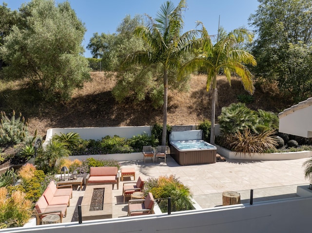 view of patio with outdoor lounge area and a hot tub