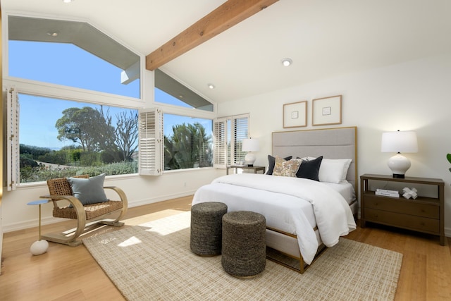 bedroom featuring vaulted ceiling with beams, baseboards, and wood finished floors