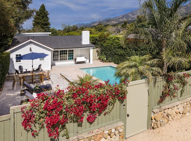 view of pool with a patio and a mountain view