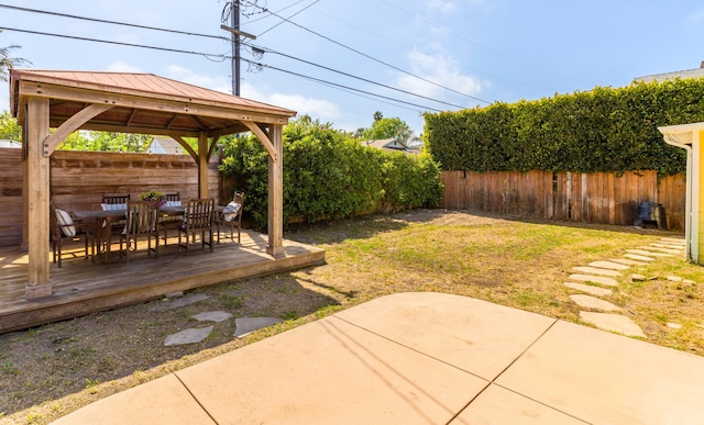 view of yard featuring a fenced backyard, outdoor dining space, a patio area, a gazebo, and a deck