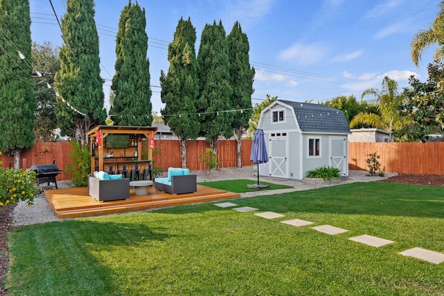 view of yard featuring a deck and a storage shed