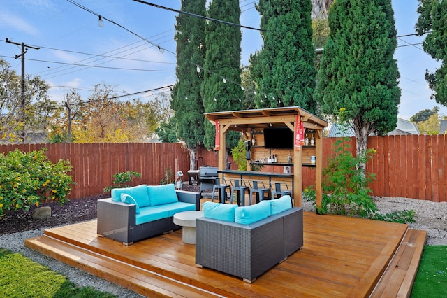 wooden deck with an outdoor living space and a grill