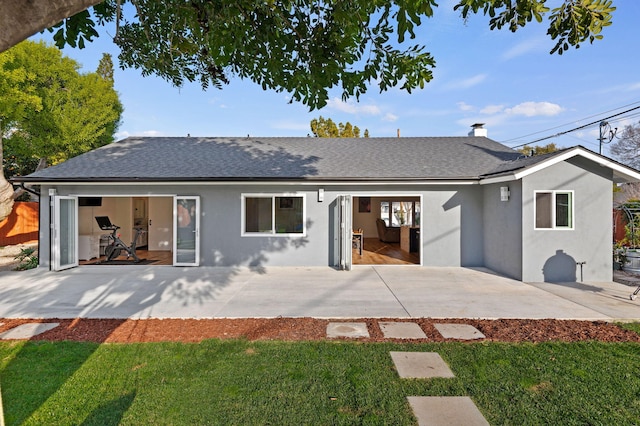 back of property featuring a yard and a patio