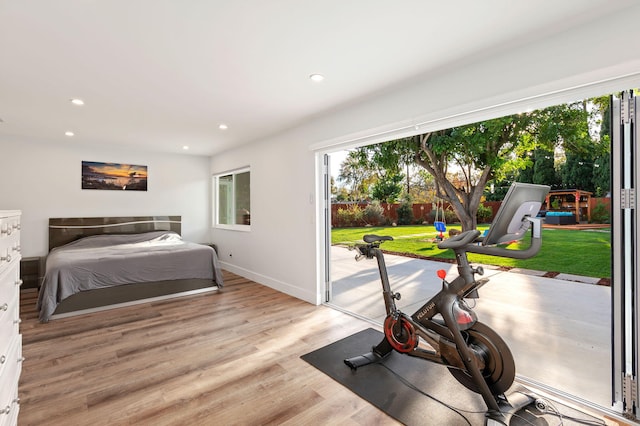 bedroom with access to exterior and light hardwood / wood-style flooring