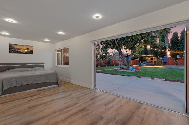 unfurnished bedroom featuring wood-type flooring and access to outside