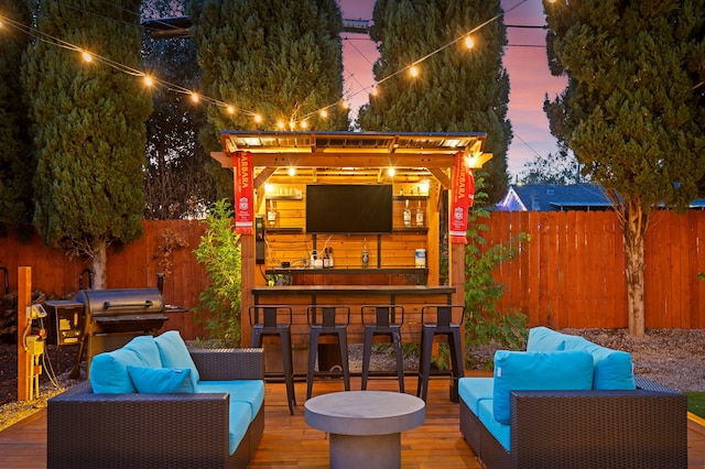 wooden deck with an outdoor living space, a grill, and an outdoor bar