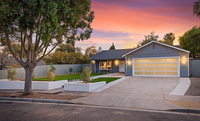 view of front facade featuring a garage and a lawn