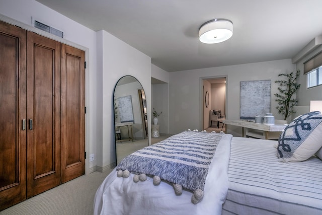 bedroom with baseboards, arched walkways, visible vents, and light colored carpet