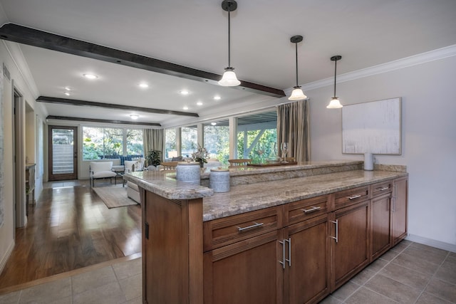 kitchen featuring beamed ceiling, a wealth of natural light, and crown molding