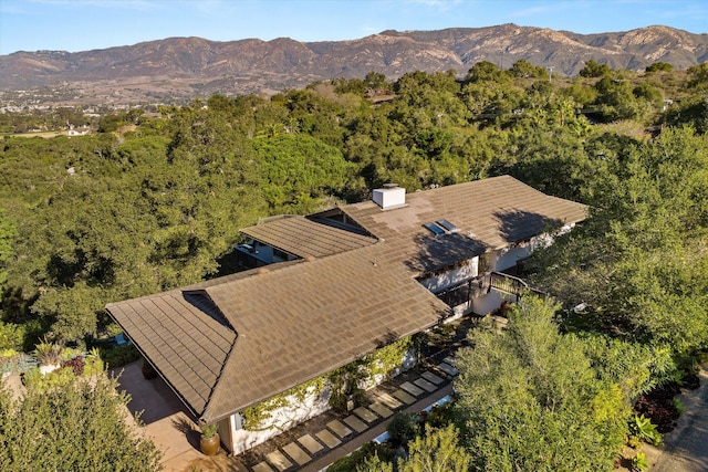 drone / aerial view with a forest view and a mountain view