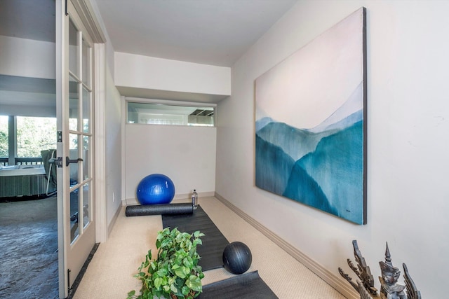 exercise area with carpet, french doors, and baseboards