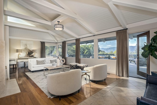 living room featuring vaulted ceiling with beams, a mountain view, and hardwood / wood-style floors