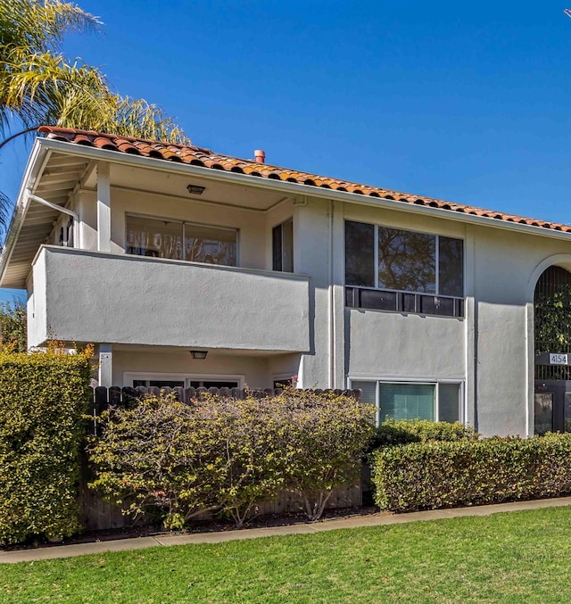 back of property featuring a balcony