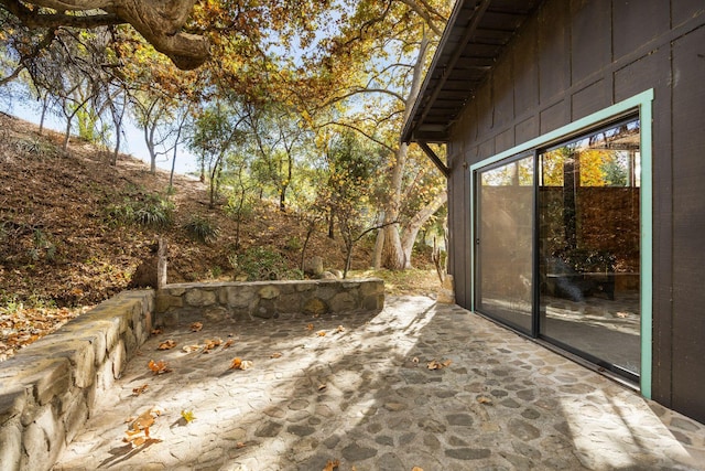 wooden terrace with a patio area