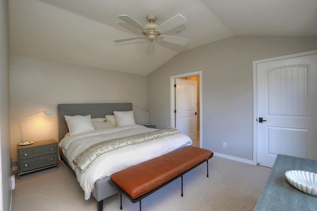 bedroom featuring ceiling fan, light colored carpet, and vaulted ceiling