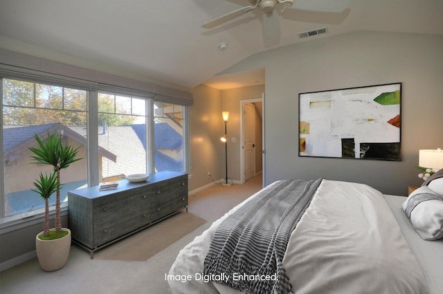 bedroom featuring baseboards, visible vents, vaulted ceiling, and light colored carpet