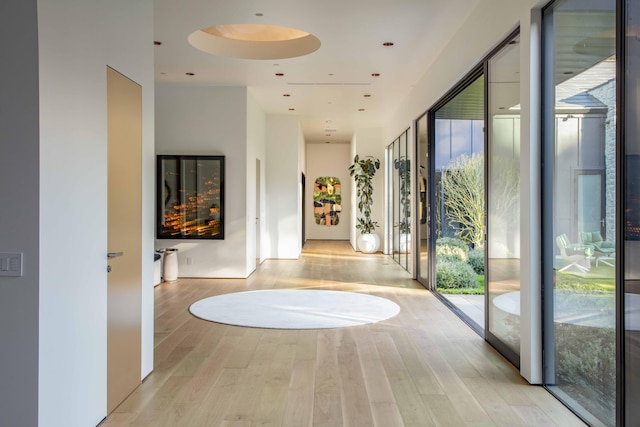 hallway with light hardwood / wood-style floors