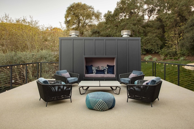 view of patio with an outdoor living space with a fireplace