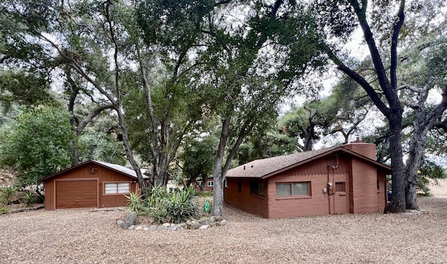 view of side of property featuring a garage and an outdoor structure