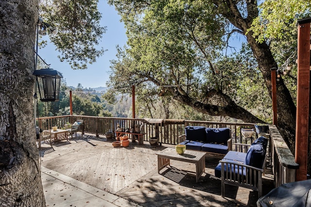 deck with a mountain view and an outdoor hangout area