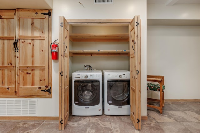 washroom with independent washer and dryer