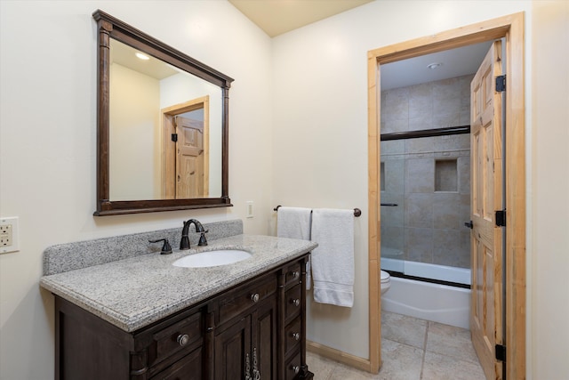 full bathroom with toilet, vanity, tile patterned floors, and enclosed tub / shower combo