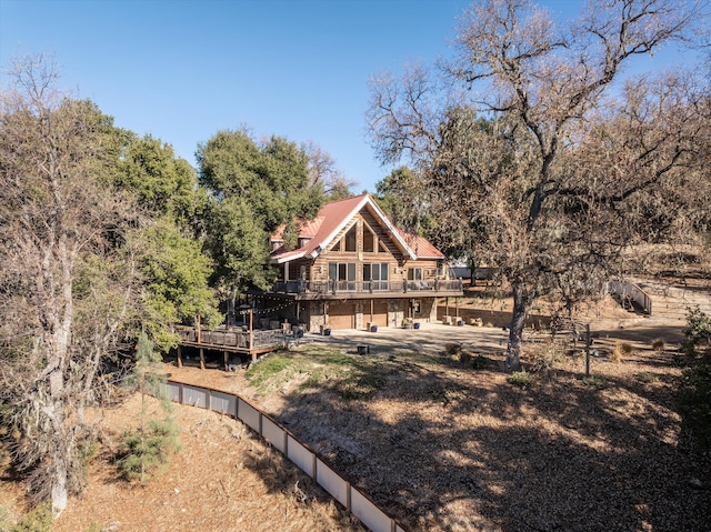 rear view of property with a wooden deck