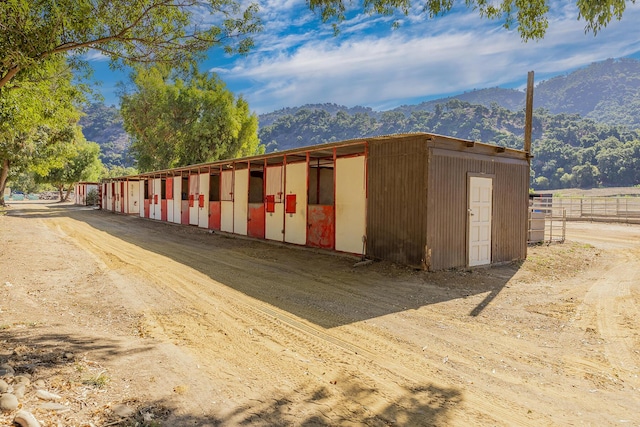 view of horse barn with a mountain view