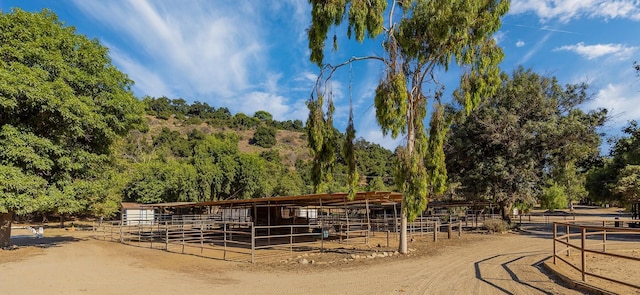 view of stable with a rural view