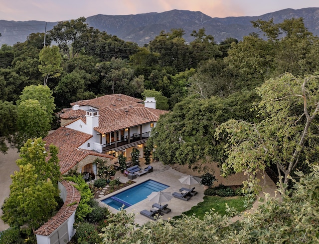 aerial view at dusk featuring a mountain view