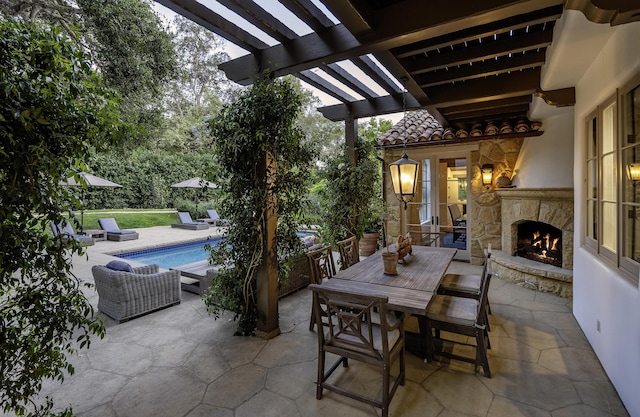 view of patio / terrace featuring an outdoor stone fireplace and a pergola