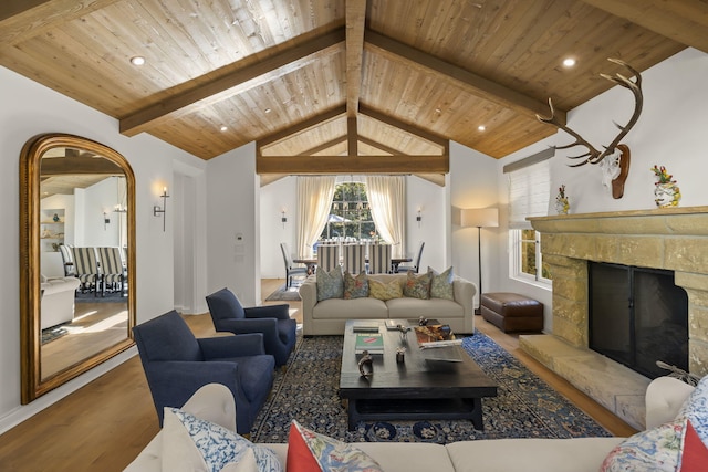 living room with hardwood / wood-style floors, lofted ceiling with beams, wood ceiling, and a fireplace